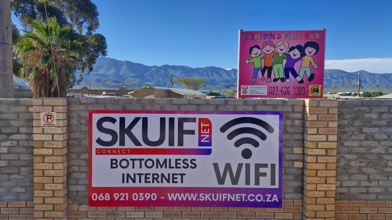 SkuifNet Bottomless Internet banner on a local brick wall