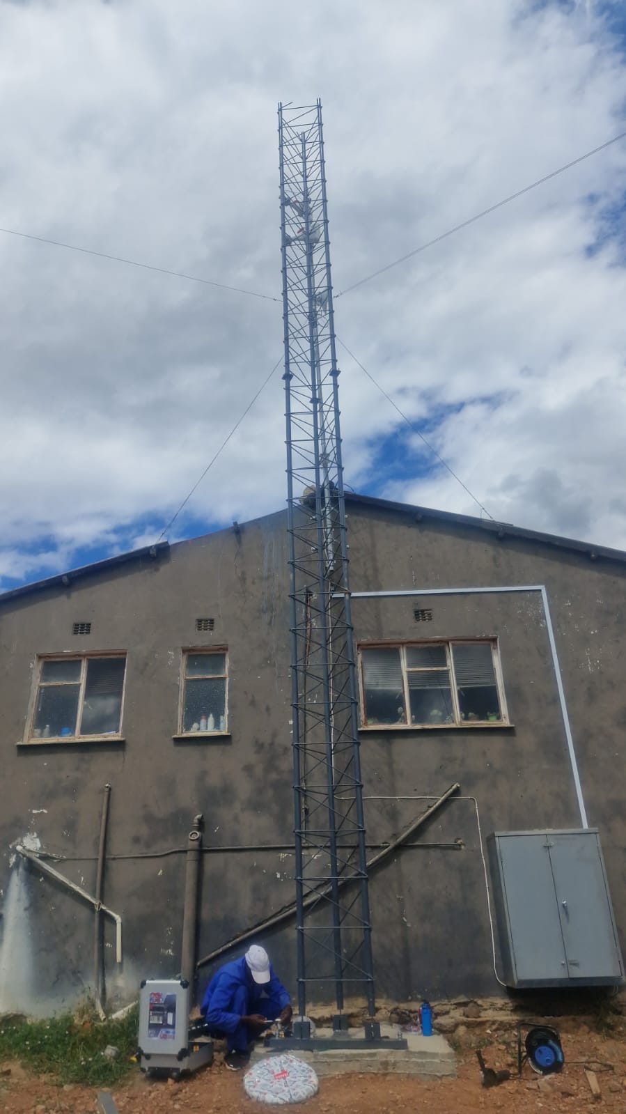 SkuifNet technician working at the base of a local lattice tower