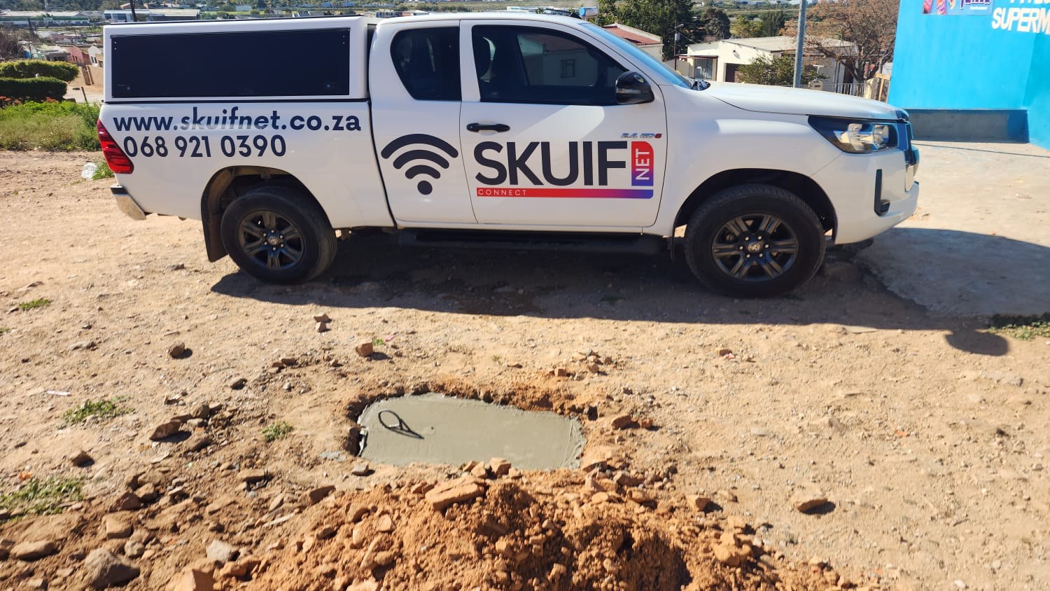 SkuifNet bakkie beside a fresh concrete foundation for network work